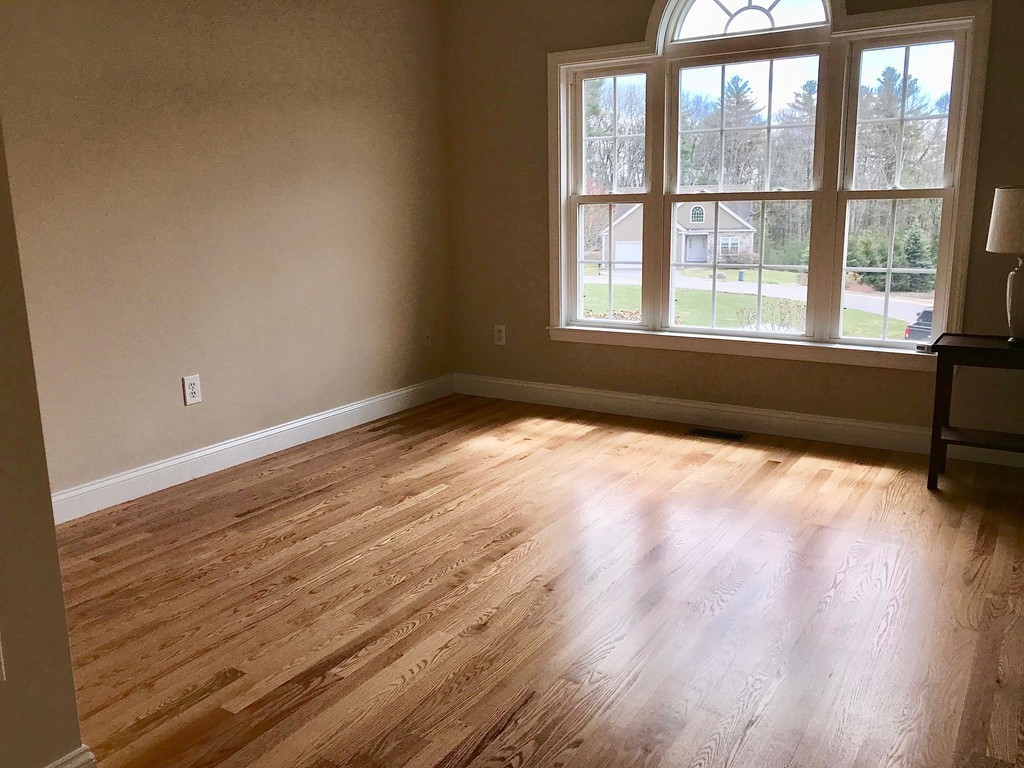 408 Nicholas Drive Lancaster, MA 01523 - Photo 15 of 30 a view of an empty room with wooden floor and a window