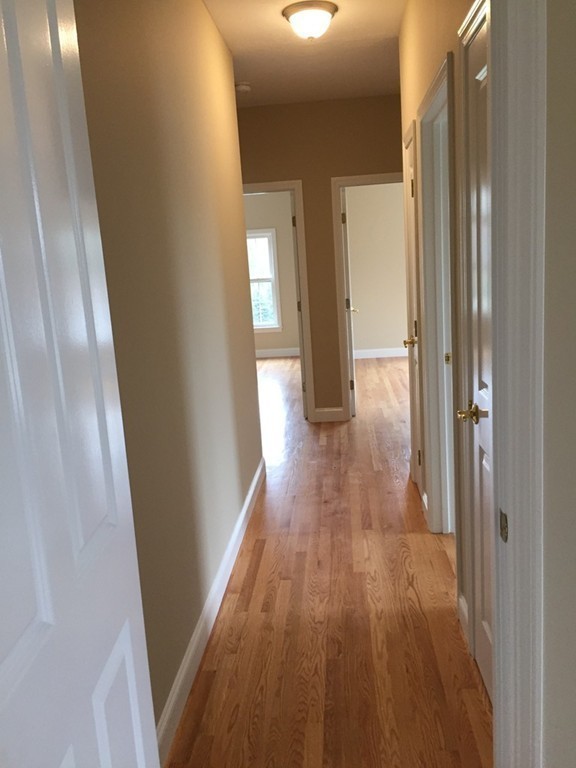 408 Nicholas Drive Lancaster, MA 01523 - Photo 16 of 30 a view of a hallway with wooden floor