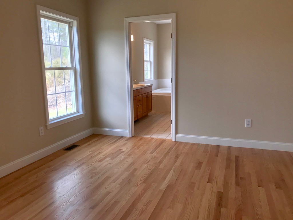 408 Nicholas Drive Lancaster, MA 01523 - Photo 17 of 30 an empty room with wooden floor and windows