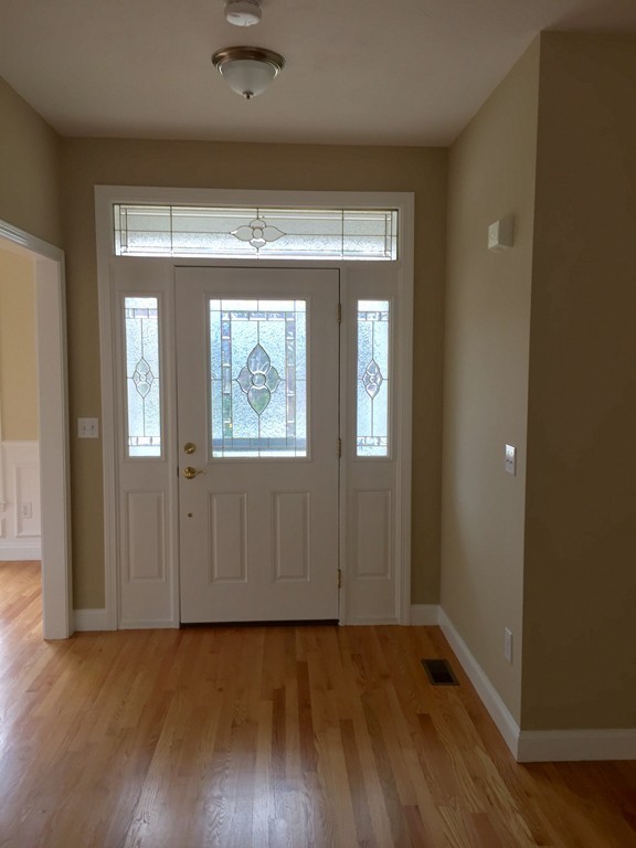 408 Nicholas Drive Lancaster, MA 01523 - Photo 2 of 30 an empty room with wooden floor and windows