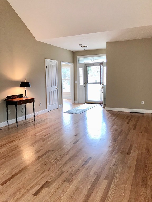 408 Nicholas Drive Lancaster, MA 01523 - Photo 4 of 30 a view of a room with wooden floor lounge chair and windows