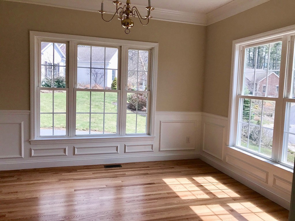 408 Nicholas Drive Lancaster, MA 01523 - Photo 6 of 30 a view of an empty room with wooden floor and a window
