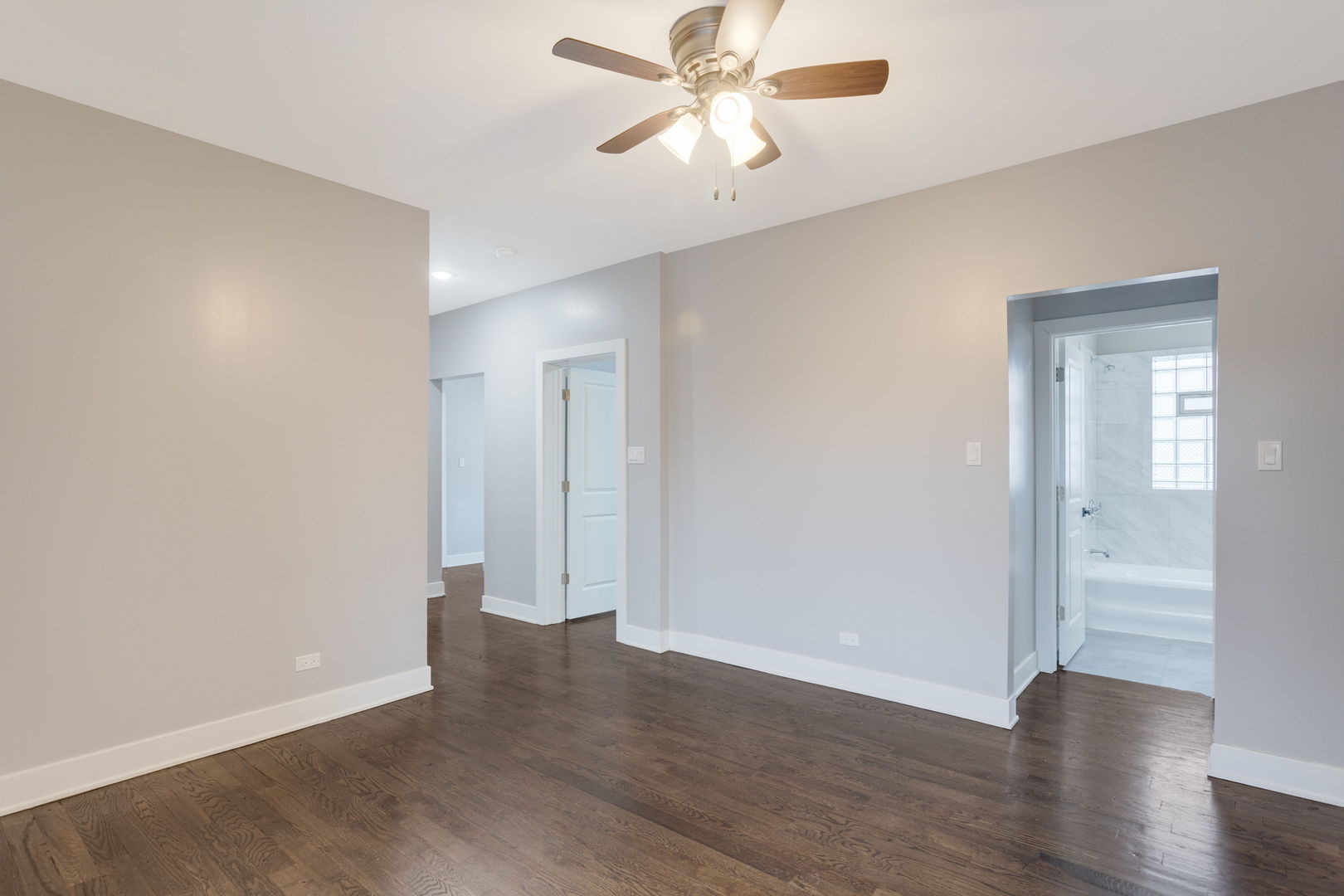 8022 South Ellis Avenue, Unit 1B Chicago, IL 60619 - Photo 4 of 8 an empty room with wooden floor and door