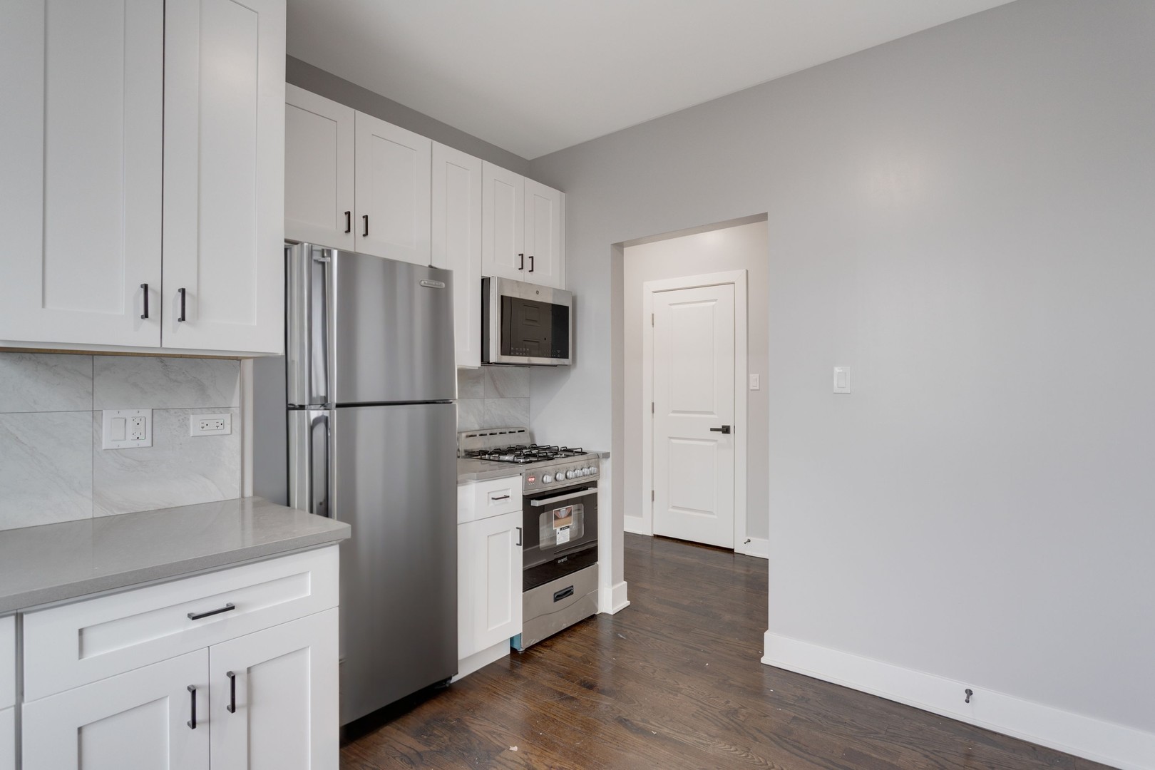 8022 South Ellis Avenue, Unit 1B Chicago, IL 60619 - Photo 5 of 8 a kitchen with stainless steel appliances a refrigerator and a stove