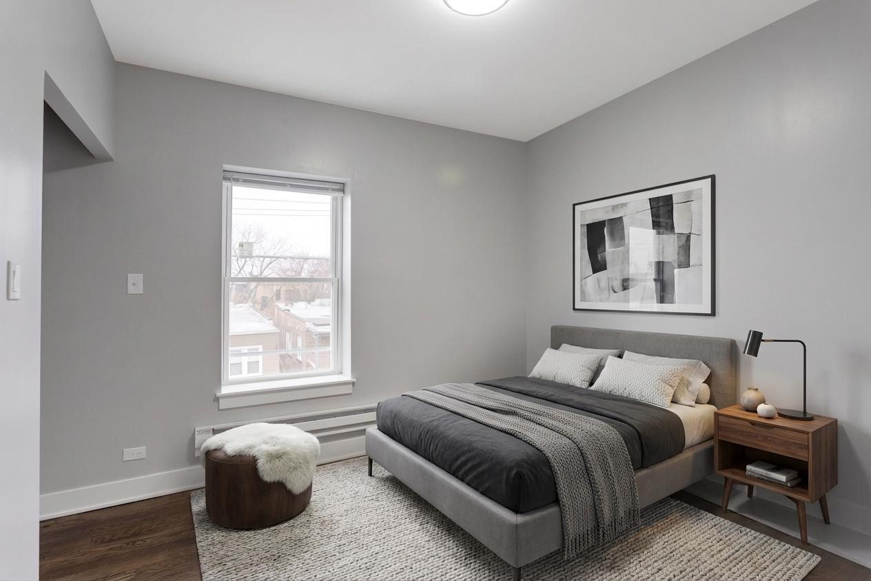 8022 South Ellis Avenue, Unit 1B Chicago, IL 60619 - Photo 7 of 8 a bedroom with a bed and painting on the wall