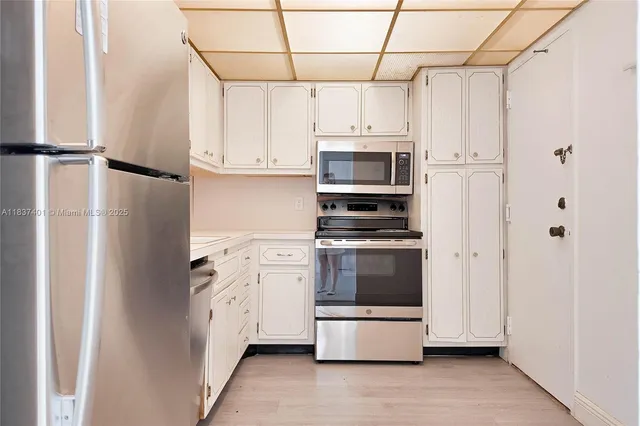 a kitchen with stainless steel appliances a refrigerator and a stove