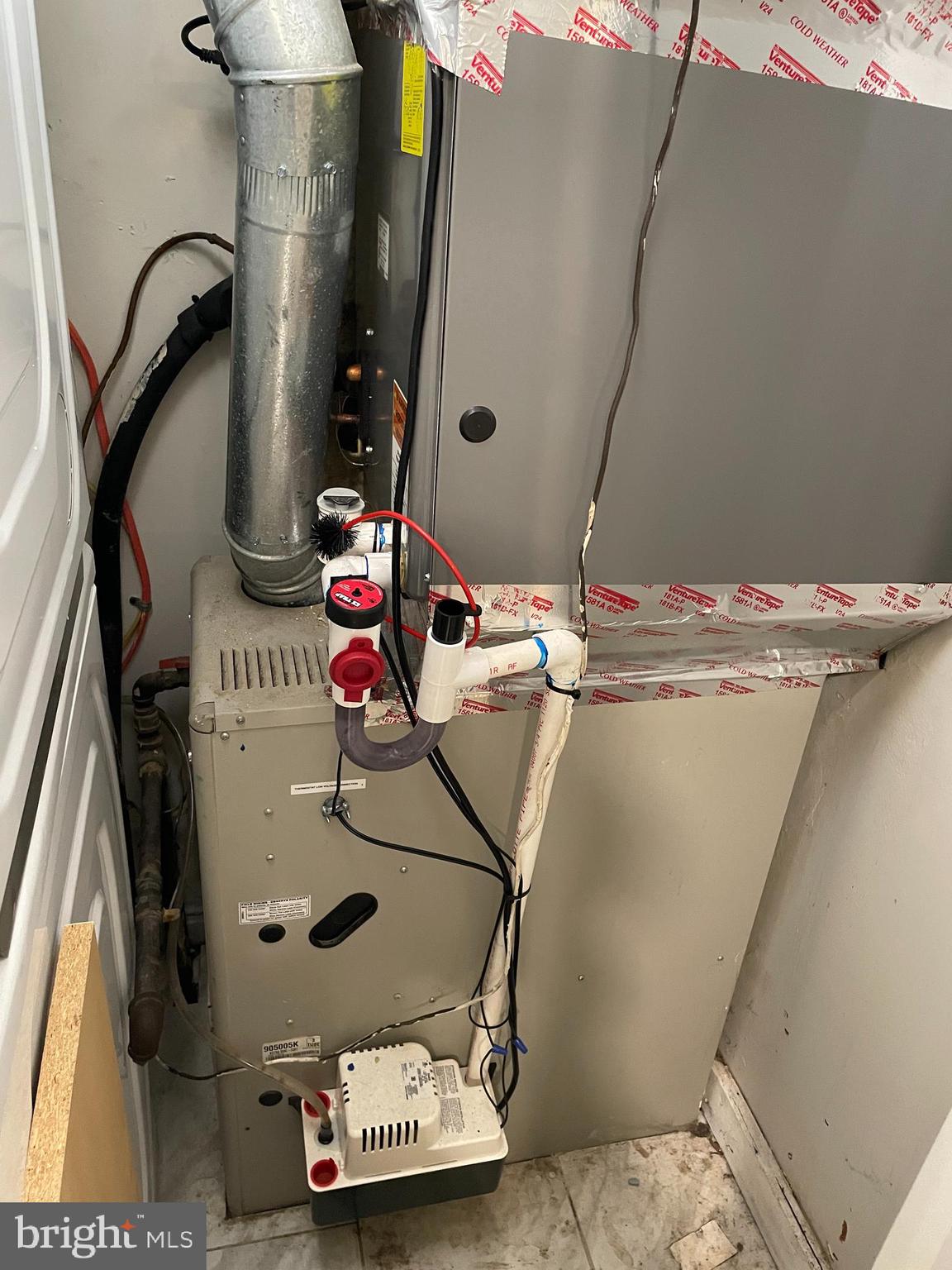 2307 Wyngate Road Suitland, MD 20746 - Photo 11 of 22 a room with water heater and wooden floor