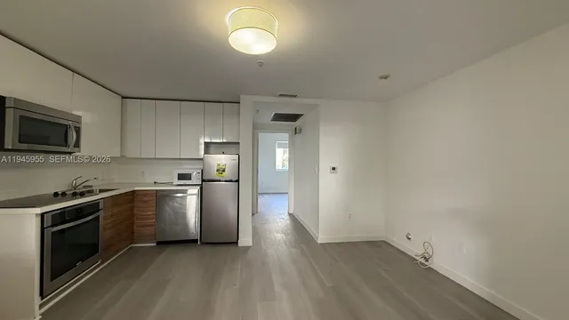 a vase of flowers sitting on a floor