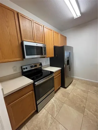 a kitchen with stainless steel appliances a stove microwave and refrigerator
