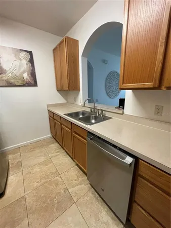 a kitchen with stainless steel appliances a sink stove and cabinets