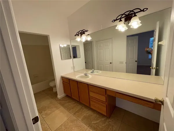 a spacious bathroom with a double vanity sink and a mirror