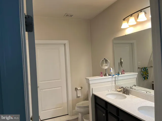 a bathroom with a sink toilet and a mirror