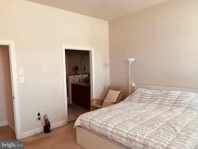 a bedroom with a bed and a walk in closet