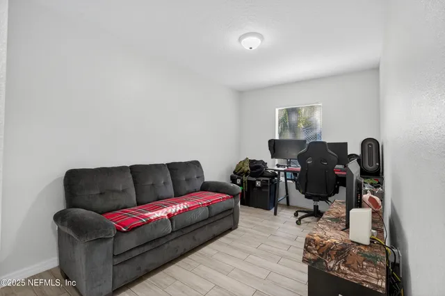 a living room with furniture and a wooden floor