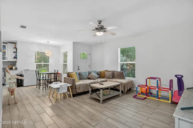 a living room with furniture and a wooden floor