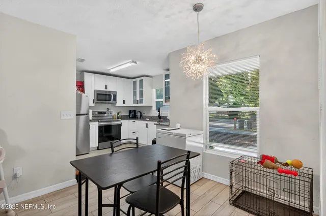 a living room with dining room and kitchen view