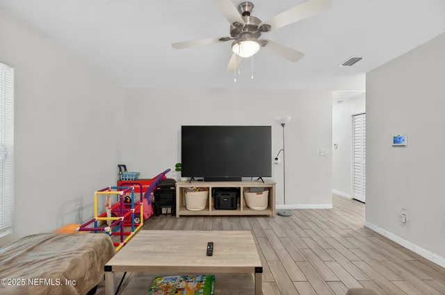 a view of a livingroom with furniture and a flat screen tv