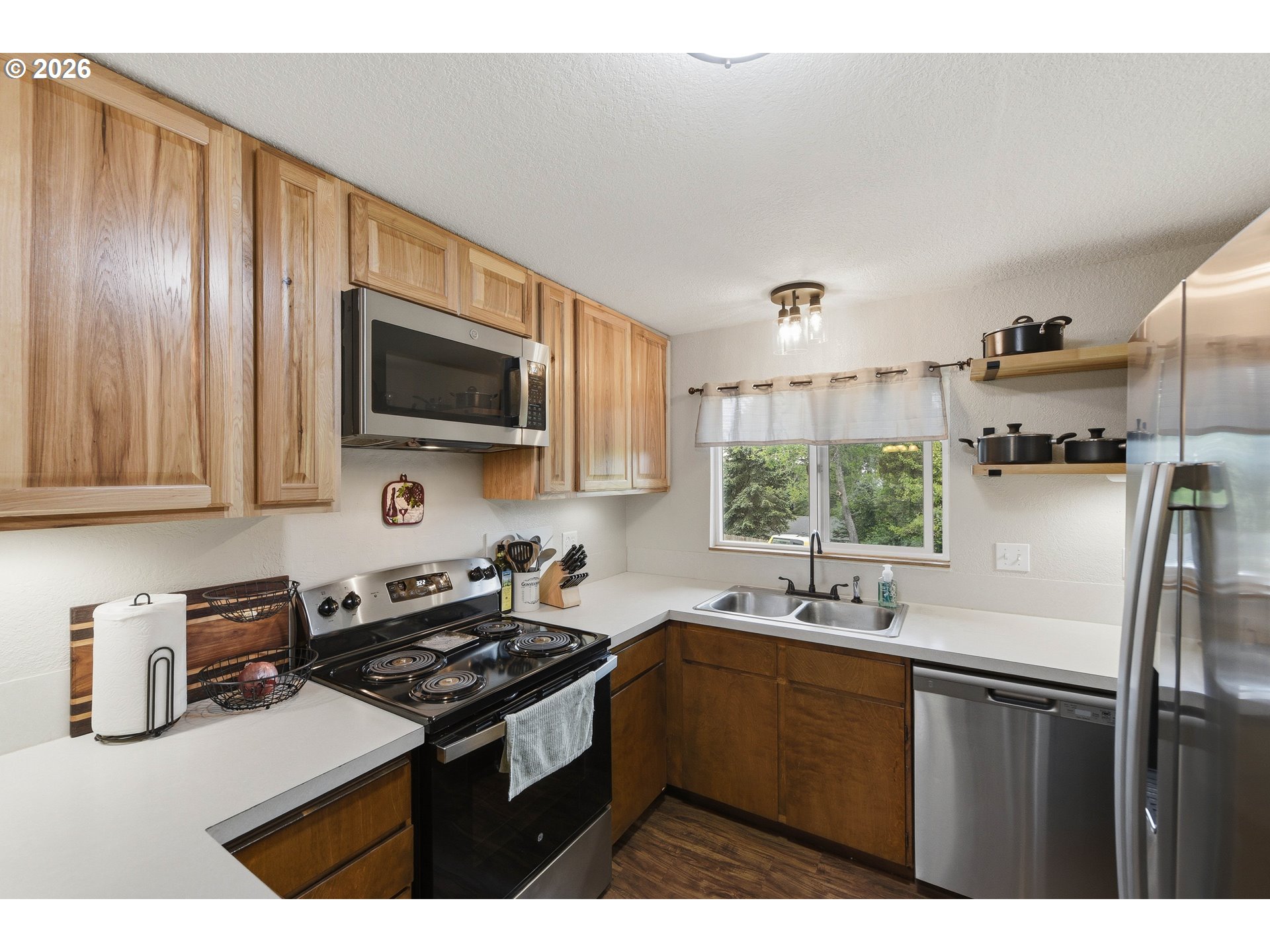 192 North Wood Ridge Road Coquille, OR 97423 - Photo 14 of 42 a kitchen with a sink stove and microwave