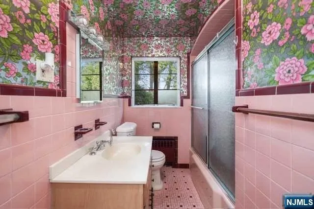 a bathroom with a sink mirror and vanity