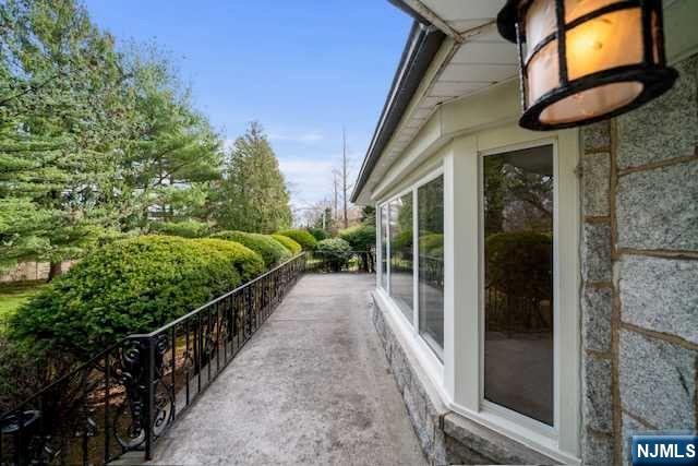 35 Old Dock Road Alpine, NJ 07620 - Photo 20 of 23 a view of a porch with a floor to ceiling window and potted plants