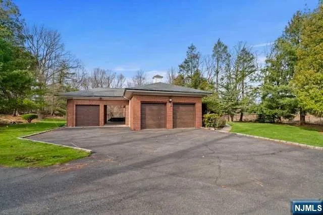 a view of a house with a yard and large tree