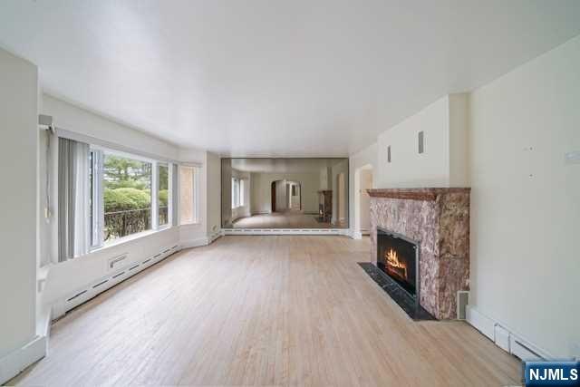 35 Old Dock Road Alpine, NJ 07620 - Photo 5 of 23 a view of empty room with wooden floor and fireplace