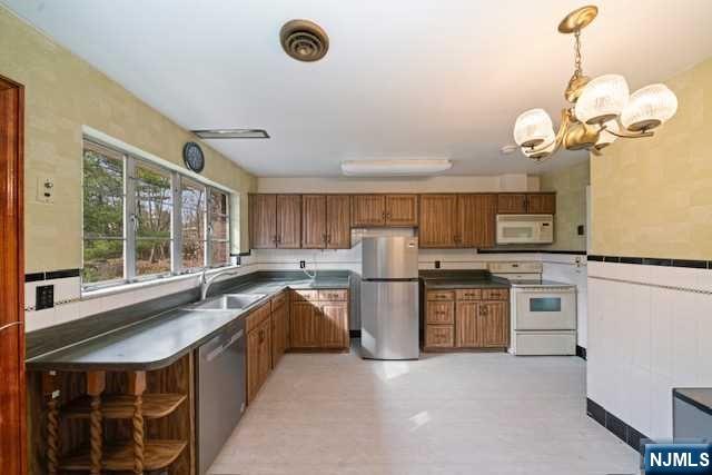 35 Old Dock Road Alpine, NJ 07620 - Photo 10 of 23 a kitchen with stainless steel appliances granite countertop a sink a stove and a refrigerator