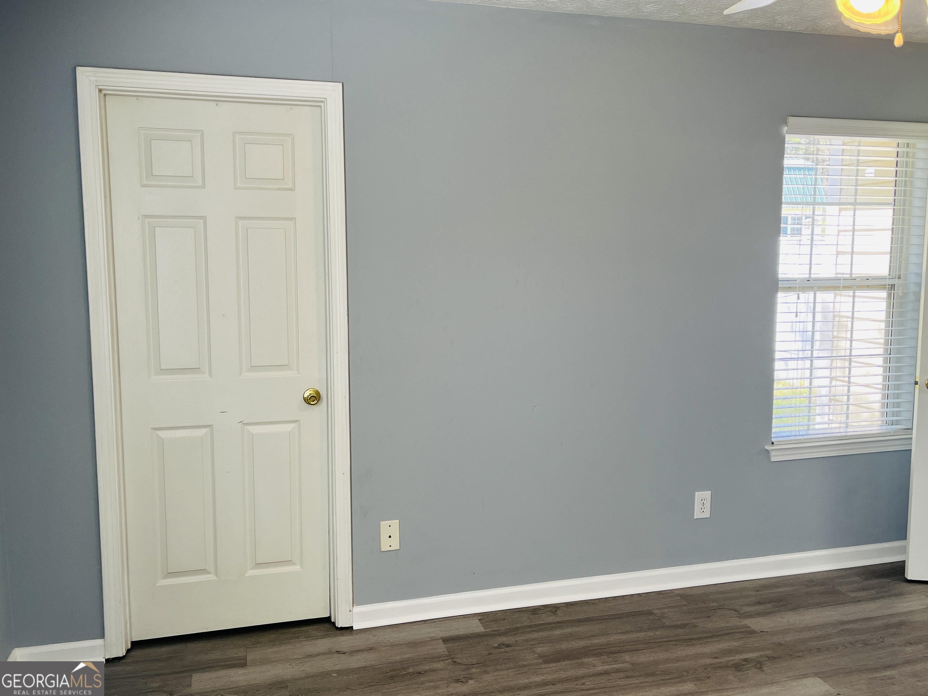 405 Peeks Crossing Drive Senoia, GA 30276 - Photo 23 of 31 an empty room with wooden floor and closet