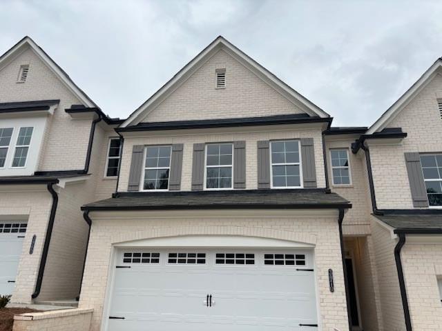 a front view of a house with garage