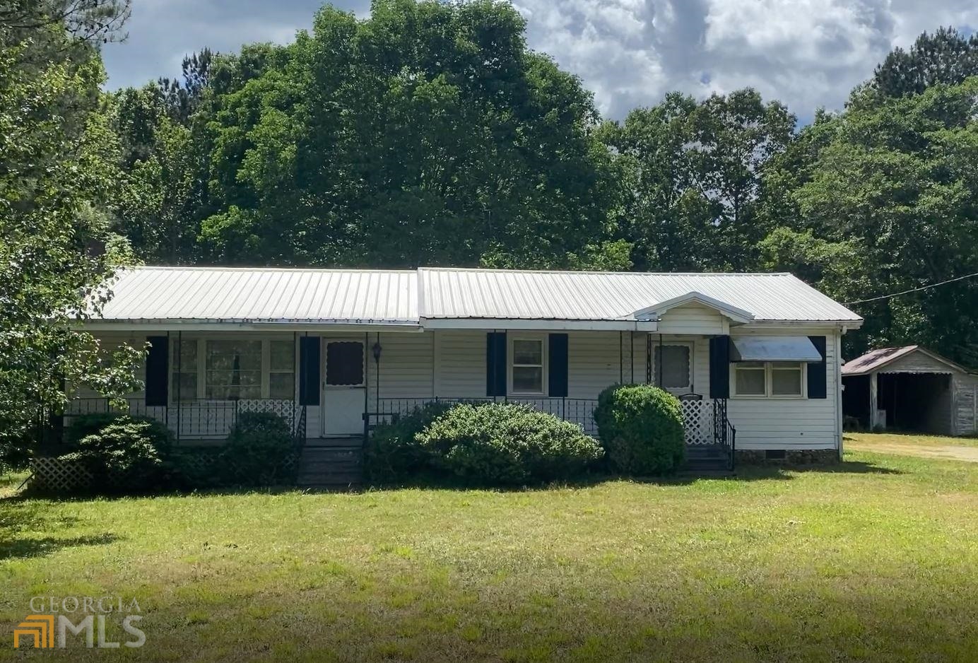 494 West Union Road Northeast Calhoun, GA 30701 - Photo 1 of 1 a view of a house with backyard and garden