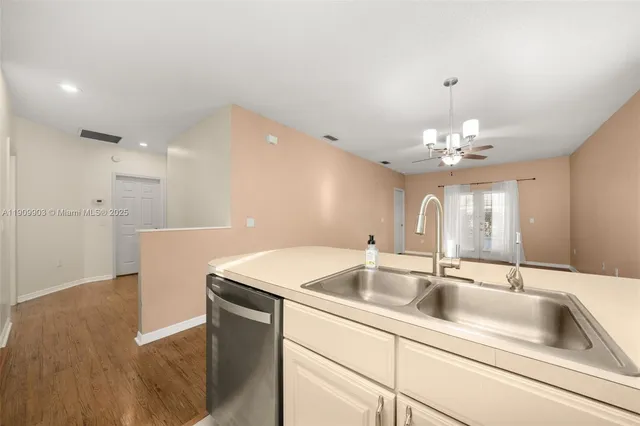 a kitchen with a sink and chandelier