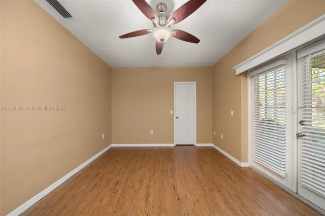 wooden floor in an empty room with a window