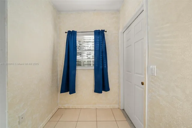 a view of an empty room with windows