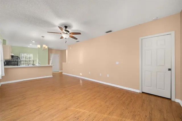 a view of an empty room with a ceiling fan