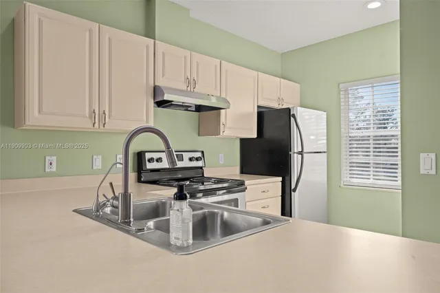 a kitchen with a refrigerator and a sink