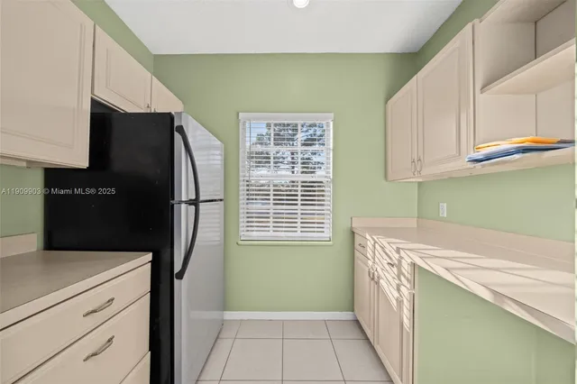 a kitchen with a refrigerator and a sink