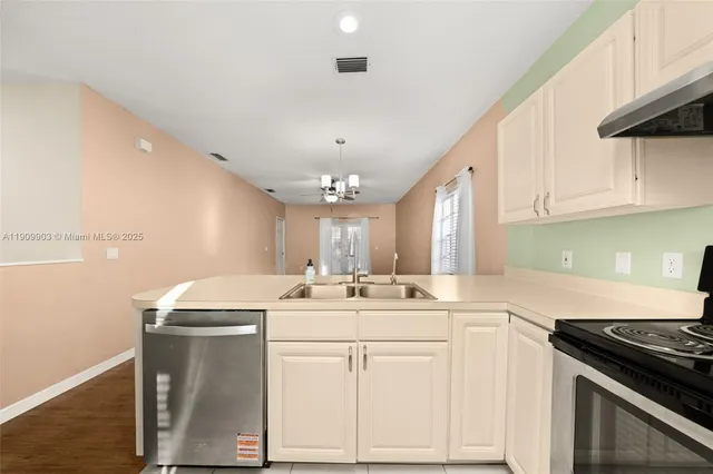 a kitchen with a sink stove and cabinets