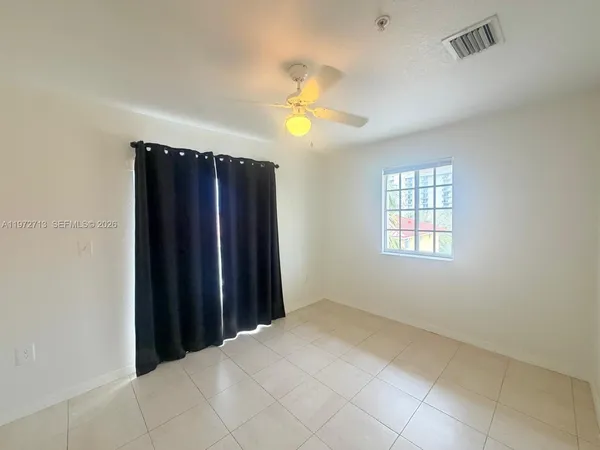 an empty room with closet and a window