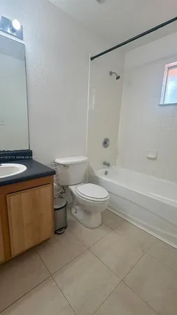 a bathroom with a toilet a sink and shower