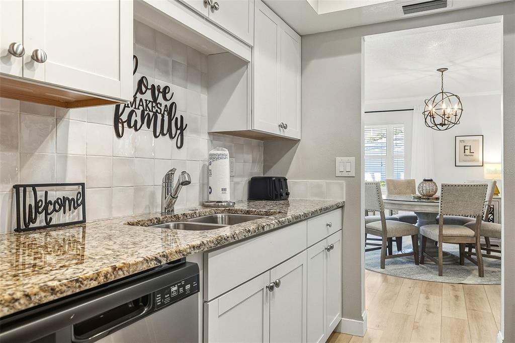 6300 Midnight Pass Road, Unit 21 Sarasota, FL 34242 - Photo 14 of 30 a kitchen with stainless steel appliances granite countertop a sink and a stove