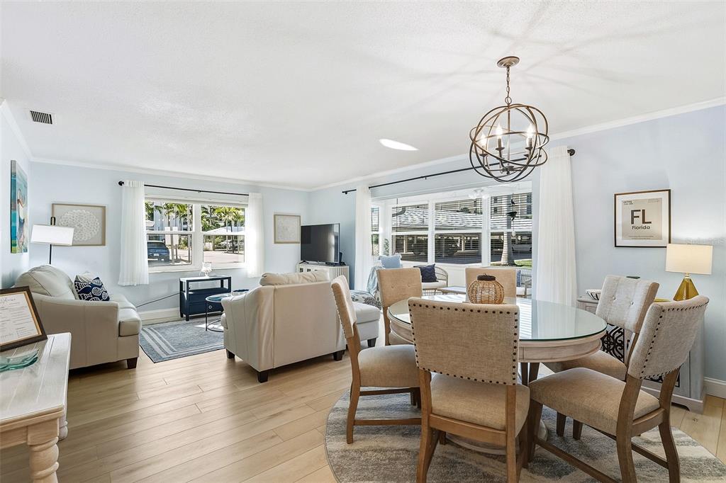 6300 Midnight Pass Road, Unit 21 Sarasota, FL 34242 - Photo 15 of 30 a living room with furniture chandelier and a large window