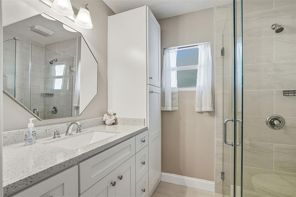 6300 Midnight Pass Road, Unit 21 Sarasota, FL 34242 - Photo 19 of 30 a bathroom with a granite countertop sink and a mirror