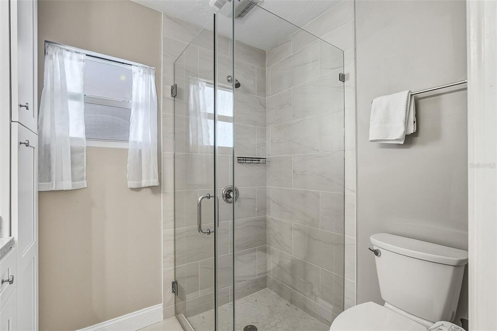6300 Midnight Pass Road, Unit 21 Sarasota, FL 34242 - Photo 20 of 30 a bathroom with a shower and toilet
