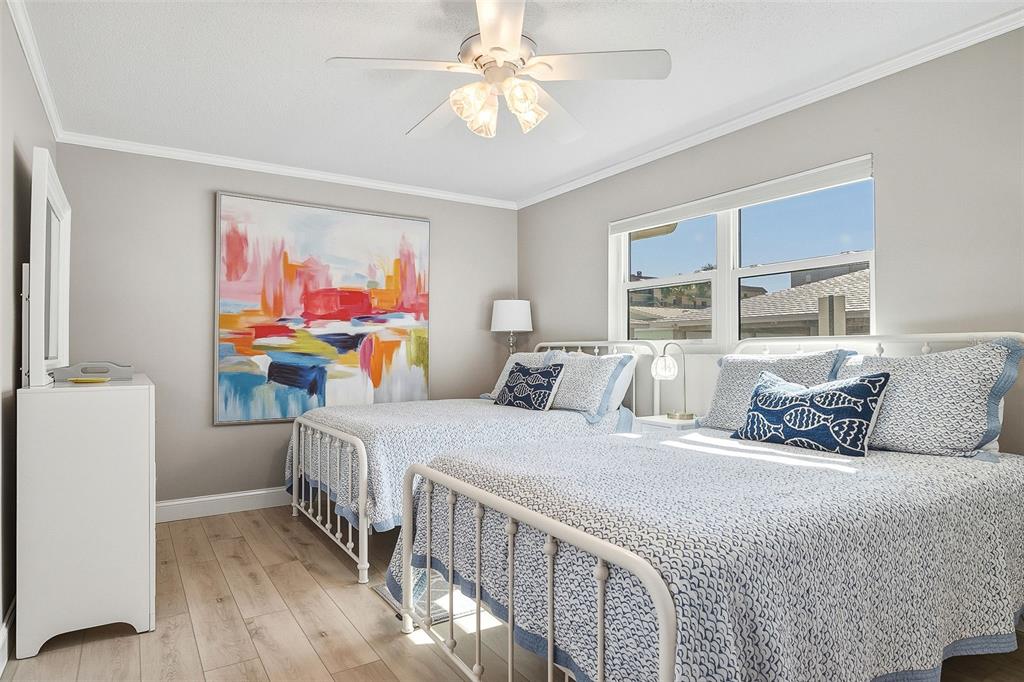 6300 Midnight Pass Road, Unit 21 Sarasota, FL 34242 - Photo 21 of 30 a bedroom with two beds and a large window