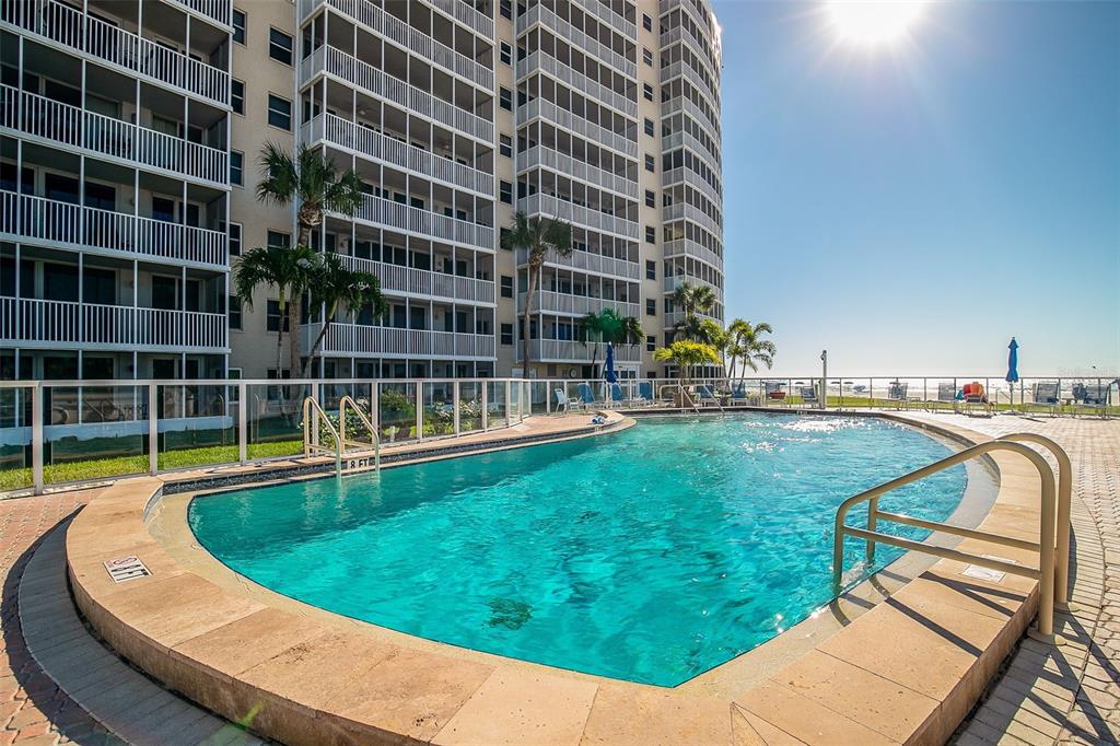6300 Midnight Pass Road, Unit 21 Sarasota, FL 34242 - Photo 26 of 30 a view of a swimming pool with a lounge chairs