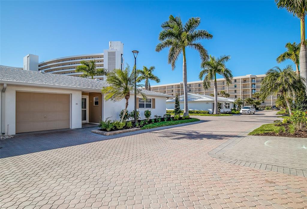 6300 Midnight Pass Road, Unit 21 Sarasota, FL 34242 - Photo 4 of 30 a front view of a house with palm trees