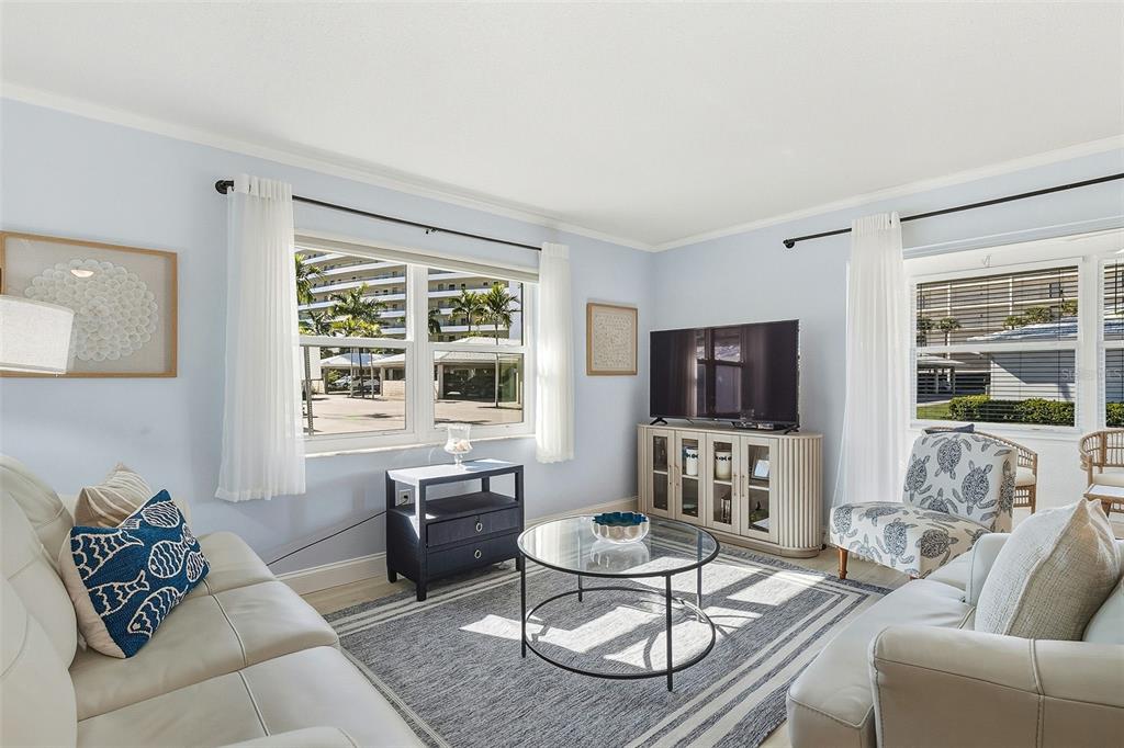 6300 Midnight Pass Road, Unit 21 Sarasota, FL 34242 - Photo 7 of 30 a living room with furniture and a flat screen tv