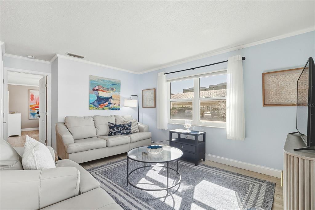 6300 Midnight Pass Road, Unit 21 Sarasota, FL 34242 - Photo 8 of 30 a living room with furniture and a large window