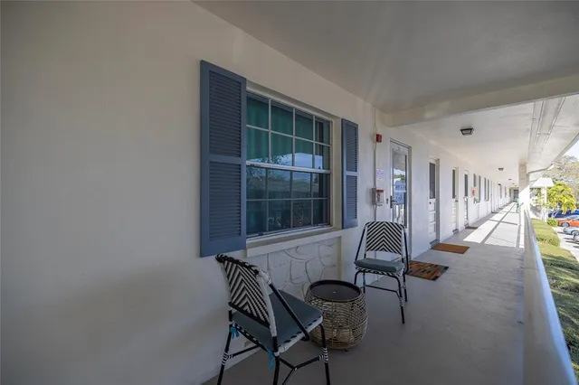 a view of a livingroom with furniture and floor to ceiling window