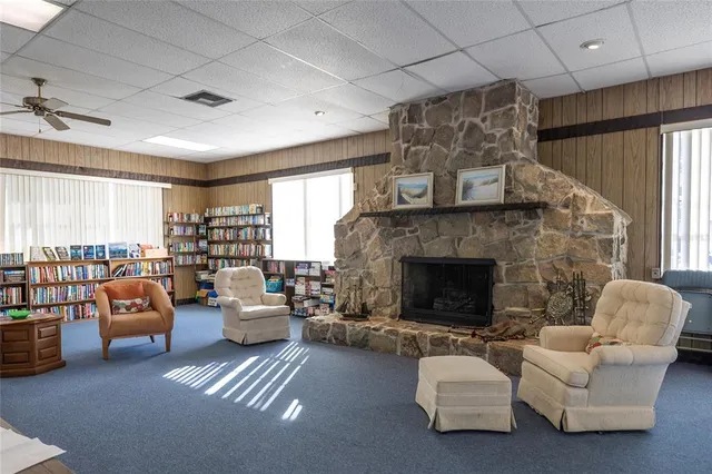 a room with a table chairs and white appliances